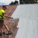 gutter guard guys painting roof as part of roof restoration service