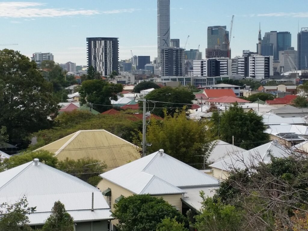Roof painting and restoration Brisbane homes with city skyline