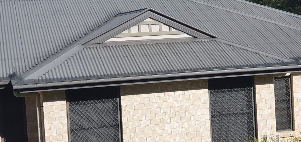 Gutter guard mesh installed on grey metal roof