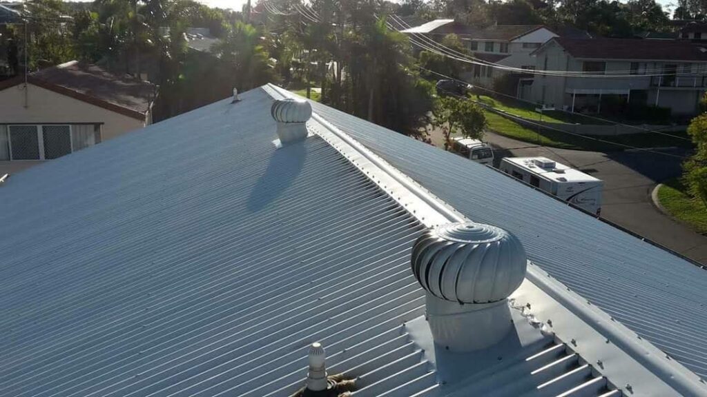 Pressure cleaned grey metal roof with two whirlybirds installed Brisbane